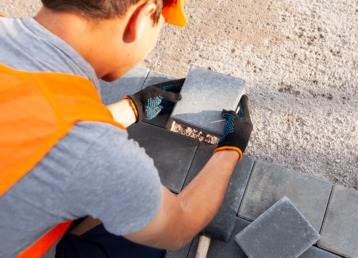 worker-lining-paving-slabs-path