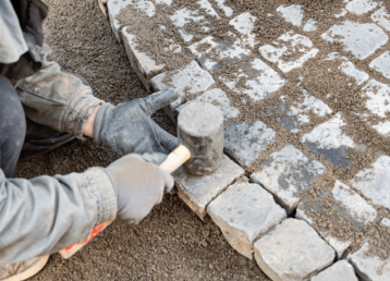 worker-making-pavement-stone-blocks-city